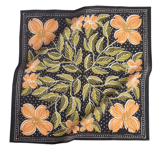 Floral patterned fabric with orange flowers and green leaves on a black background