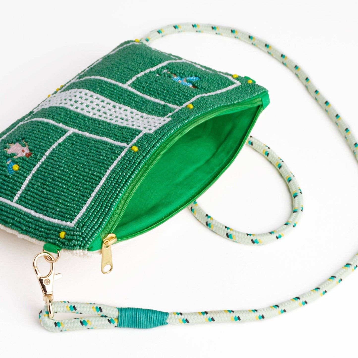 Green beaded pouch with a tennis court design and matching strap on a white background