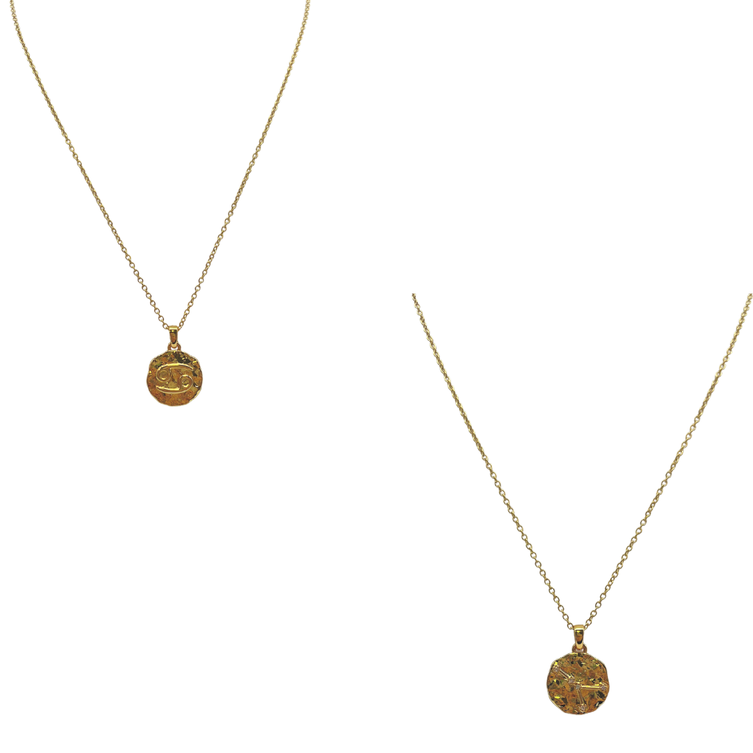 Two gold necklaces with round pendants on a white background