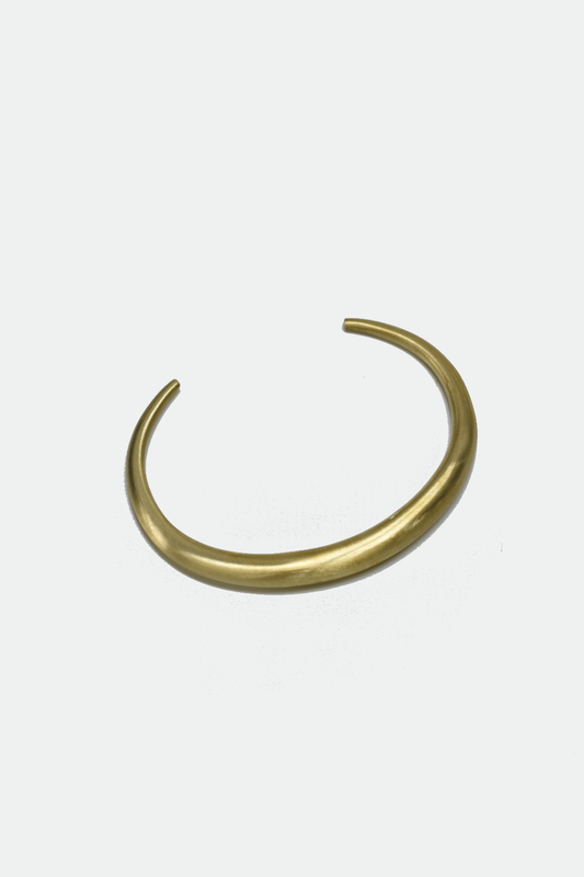 Gold bangle on a white background