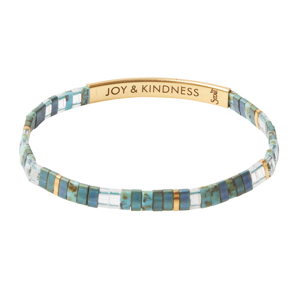 Bracelet with 'JOY & KINDNESS' inscription on a white background
