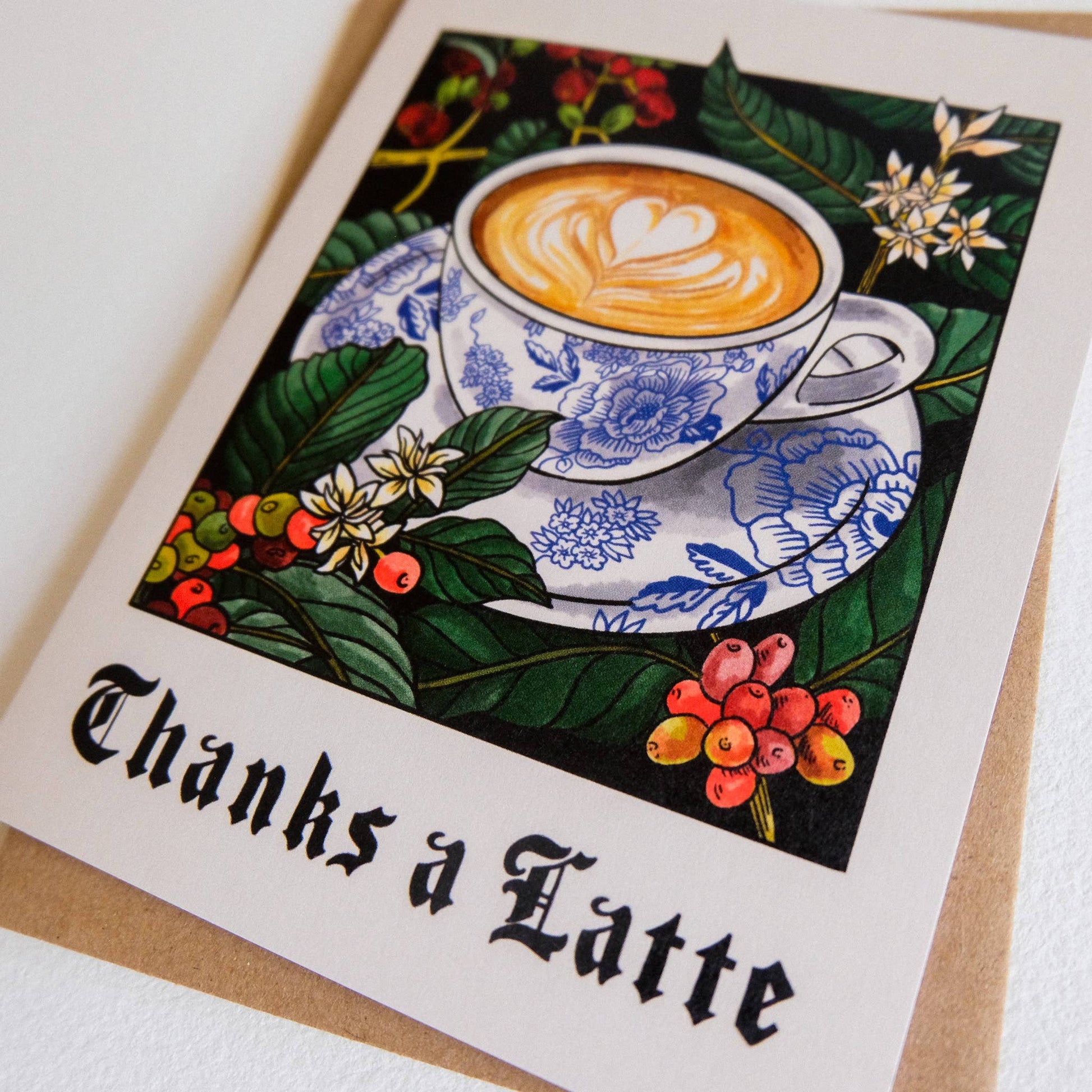 Greeting card with a coffee cup illustration and 'Thanks a Latte' text on a white background.