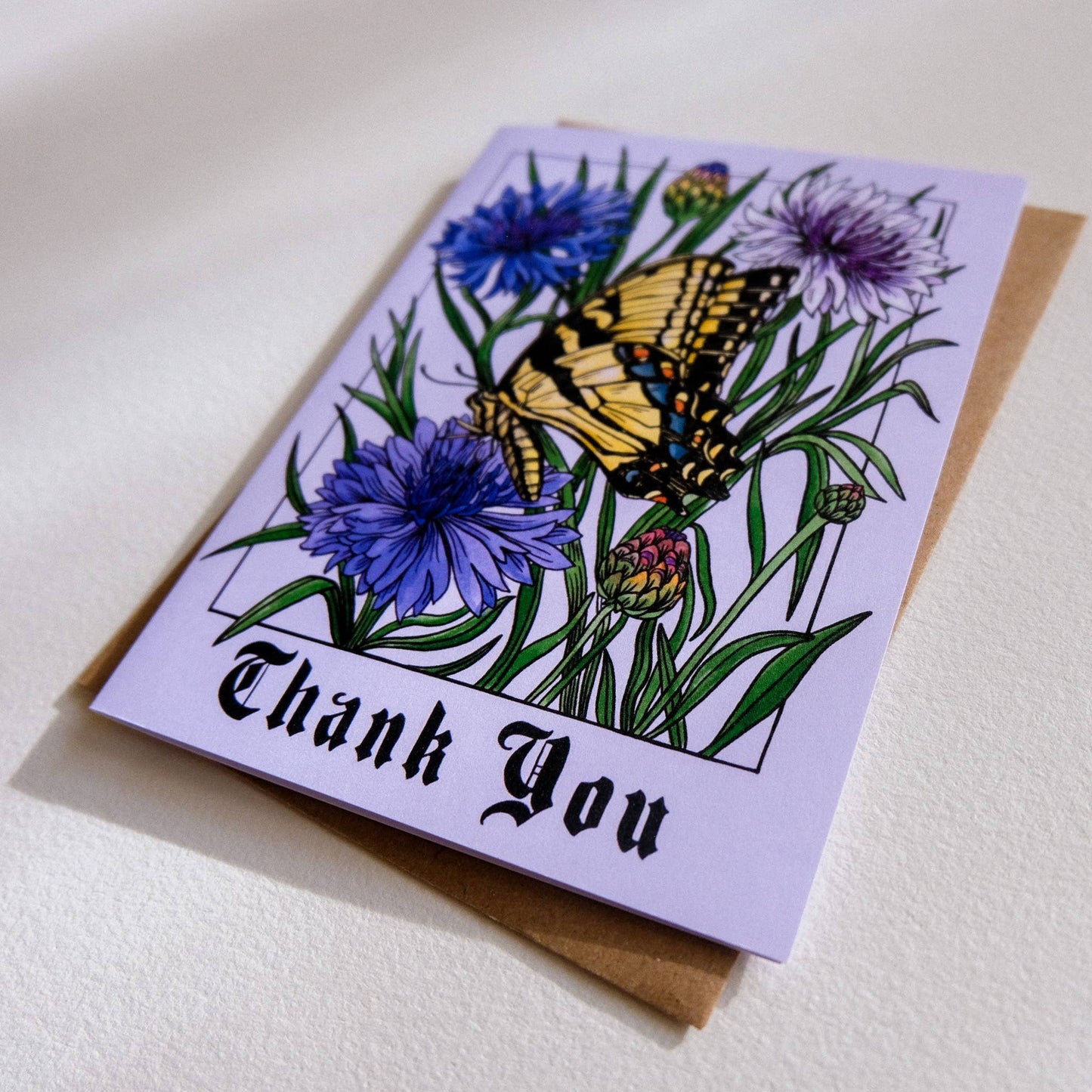 Greeting card with a butterfly and flowers design on a white background