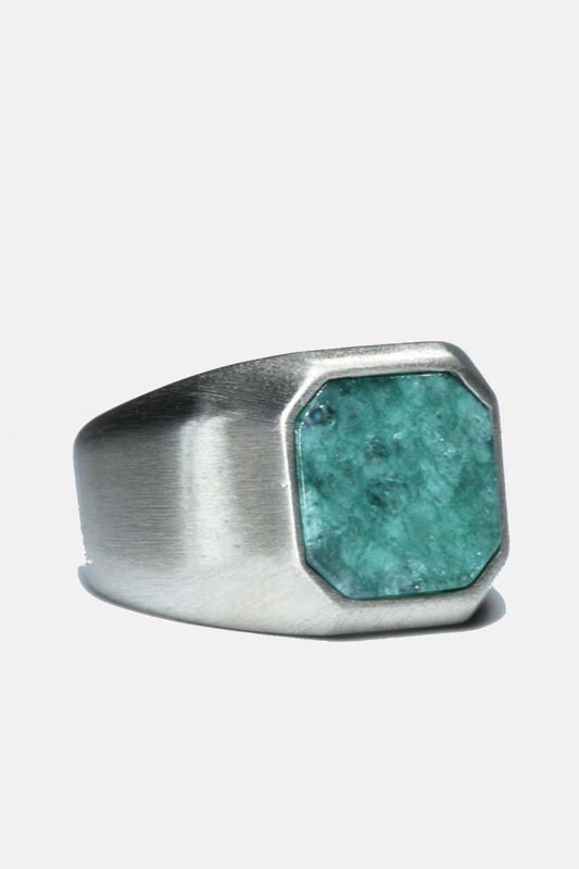 Silver ring with a turquoise stone on a white background