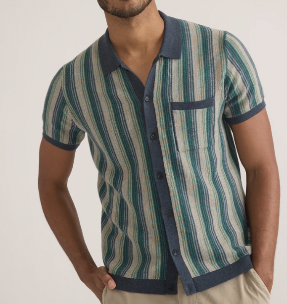 A man wearing a navy and green striped button-down knit shirt