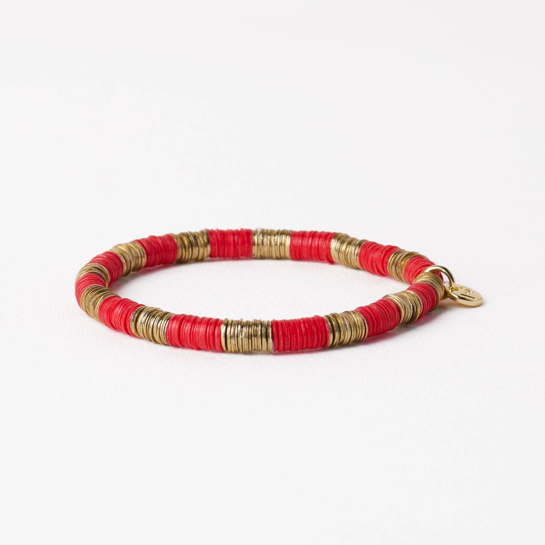 Bracelet with red and gold beads on a white background