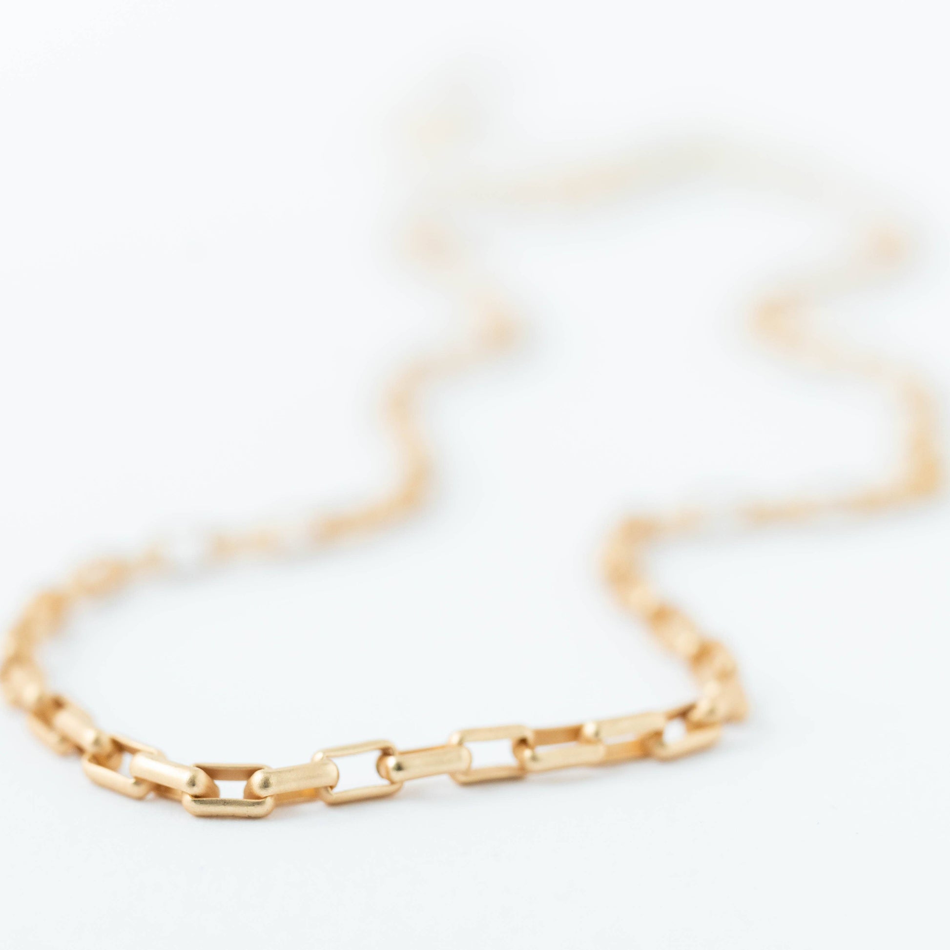 Gold chain bracelet on a white background
