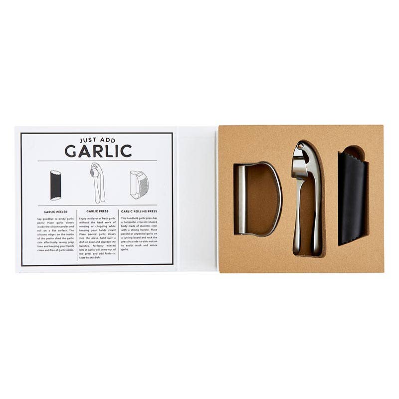 Set of garlic press and peeler tools in a box with instructions on a white background