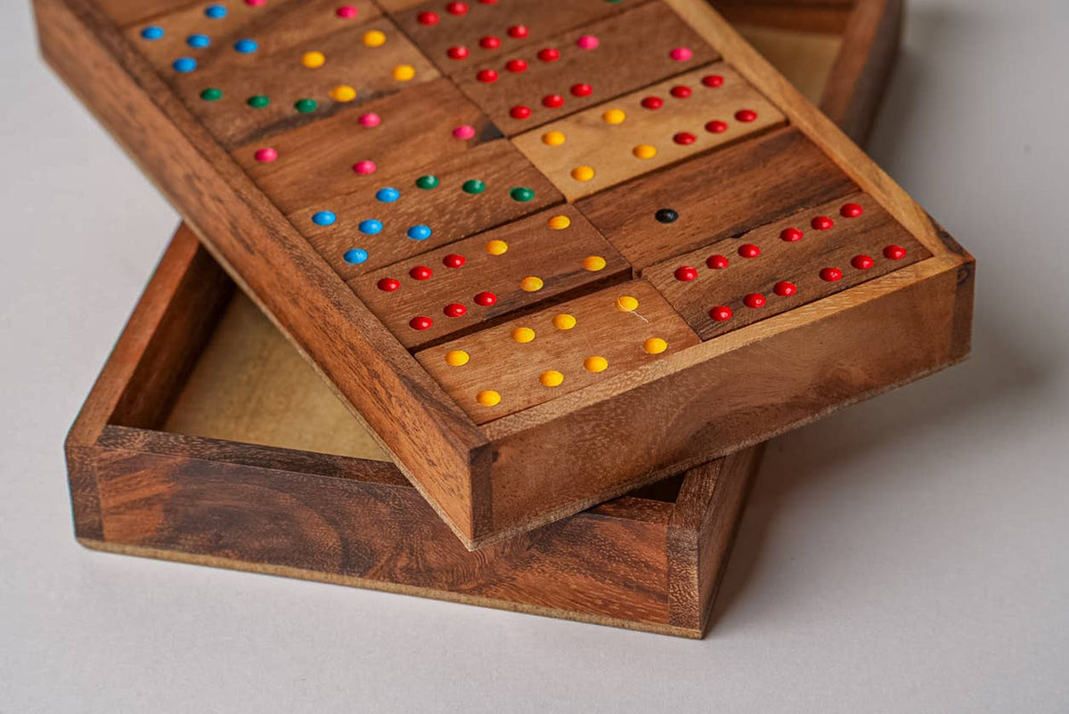 Wooden game board with colorful dots on a light gray background