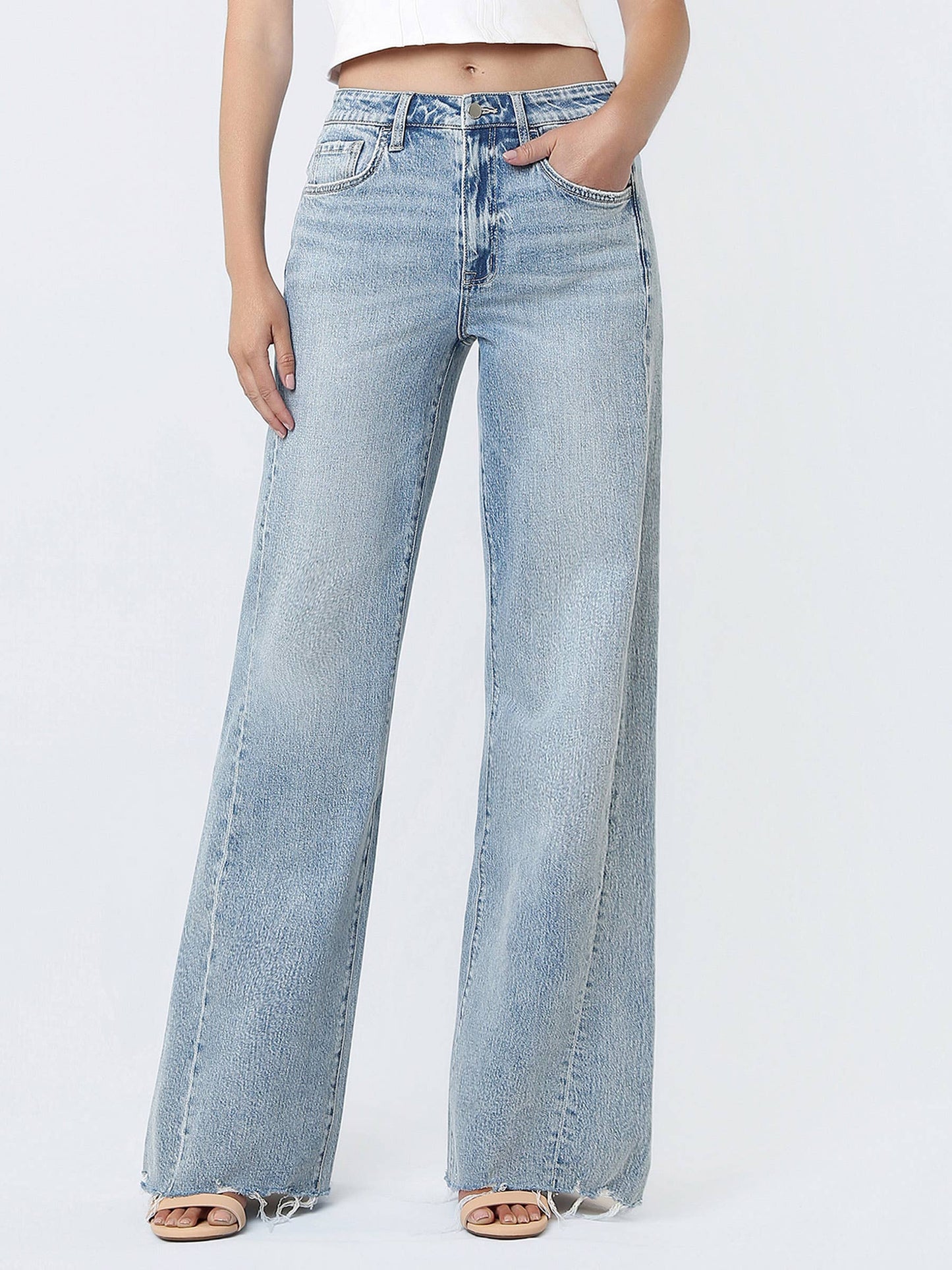 Light blue jeans worn by a person on a white background