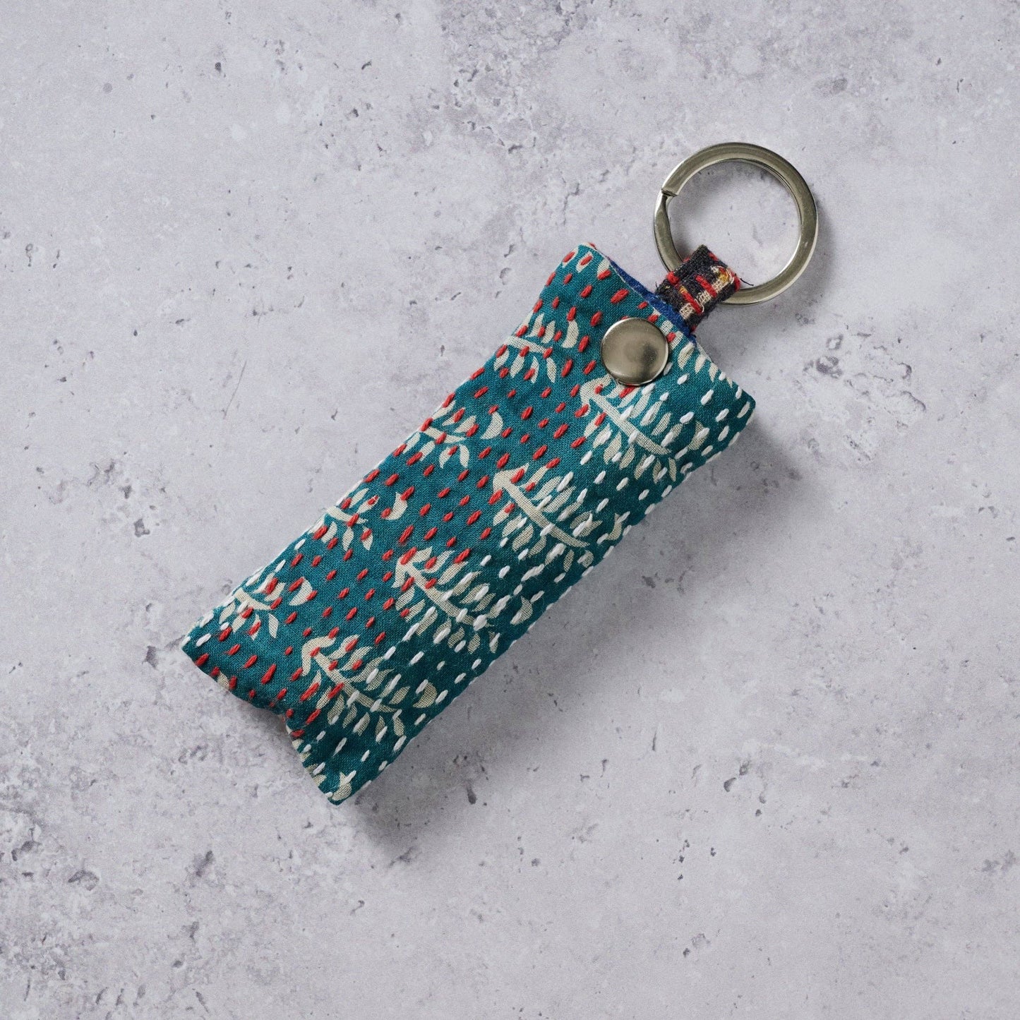 Fabric key fob with a pattern on a textured gray surface