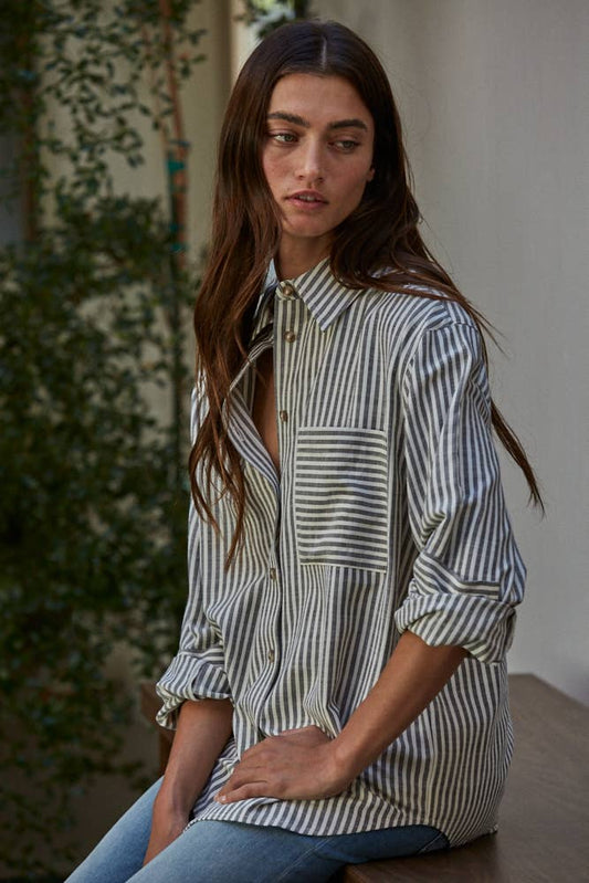 Striped button-down top with collar, long sleeves, front chest pocket, and relaxed fit in a cotton-polyester blend.