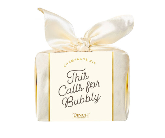 Gift box labeled 'This Calls for Bubbly' with a satin ribbon on a white background