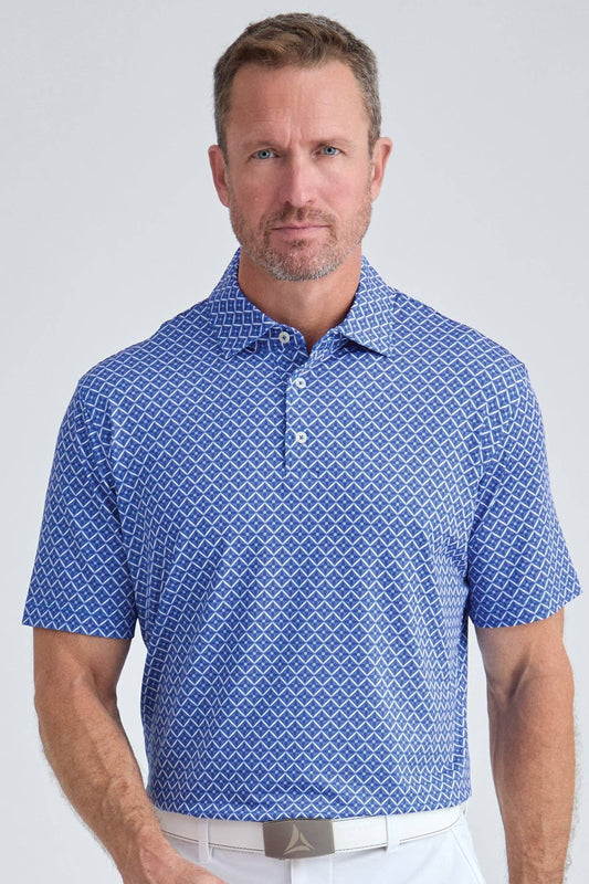 Man wearing a blue patterned polo shirt against a light gray background