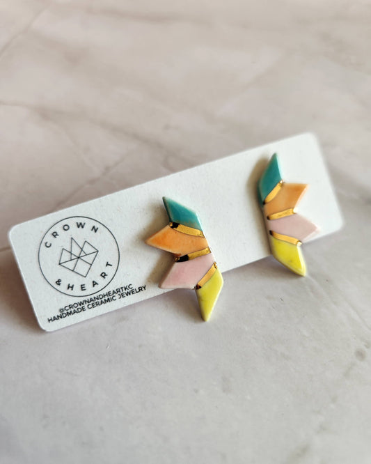 Colorful geometric earrings on a white card with 'Crown & Heart' branding.