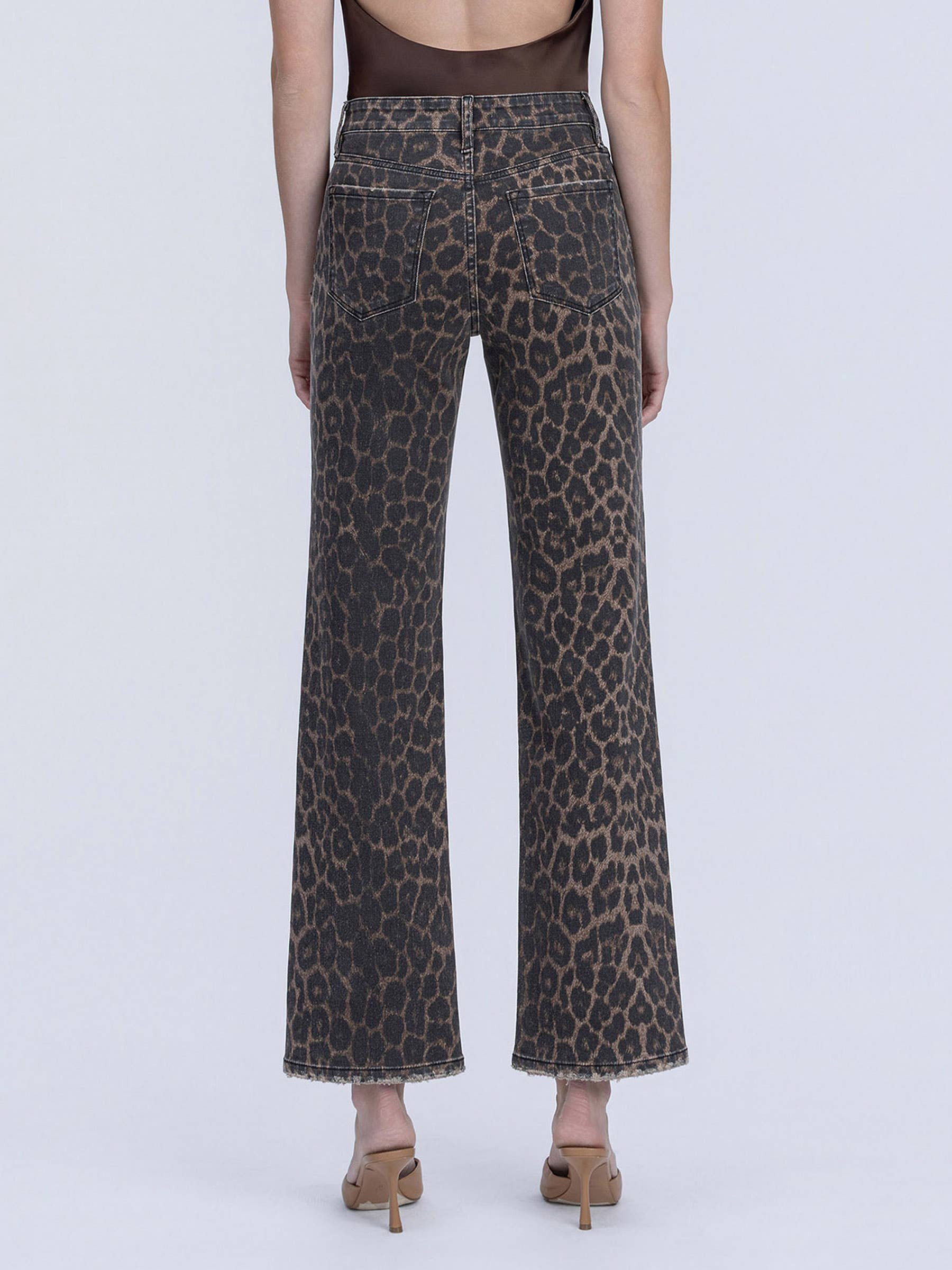 Leopard print pants worn by a person on a white background