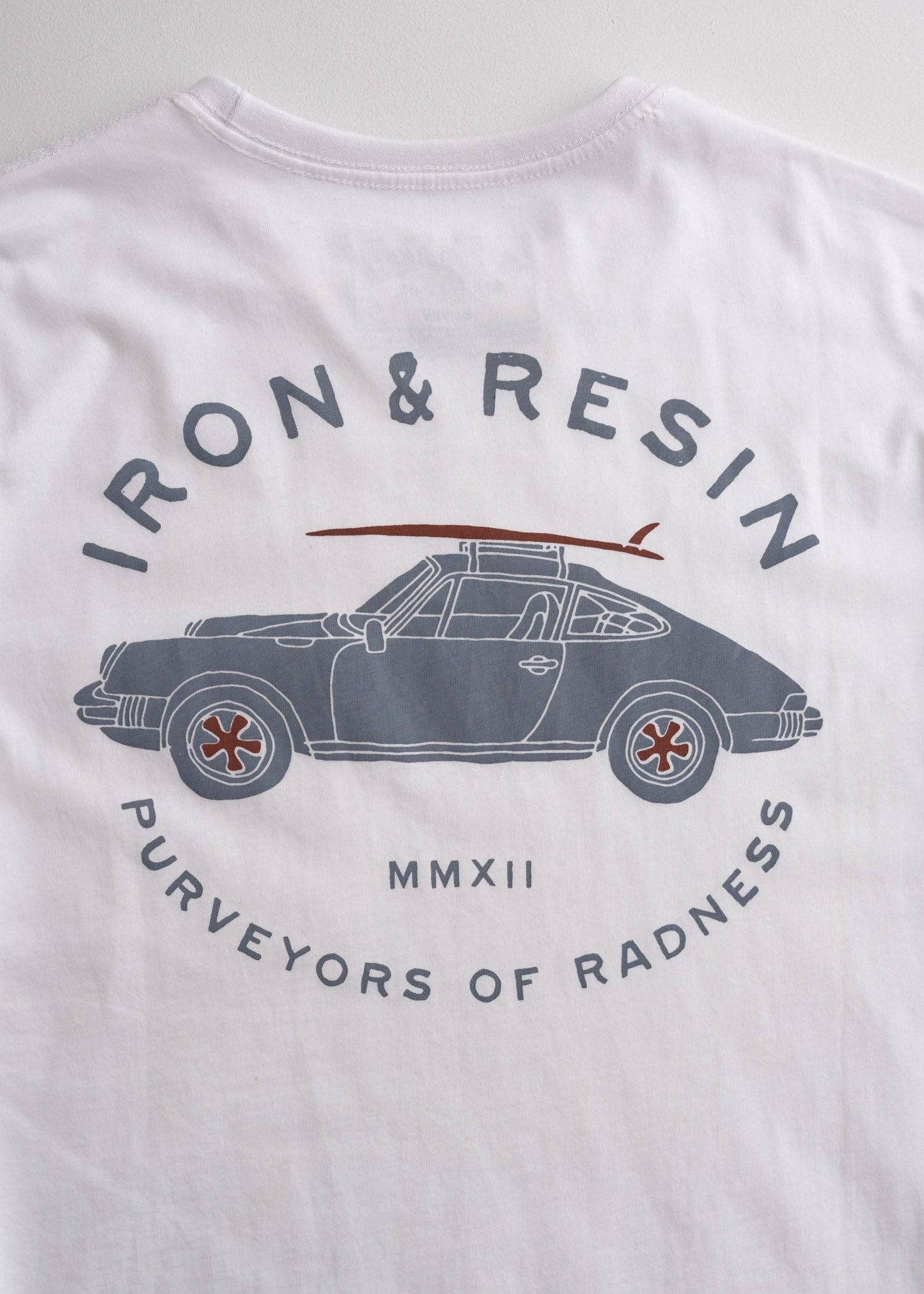 White t-shirt with car graphic and 'Iron & Resin' branding on a light gray background