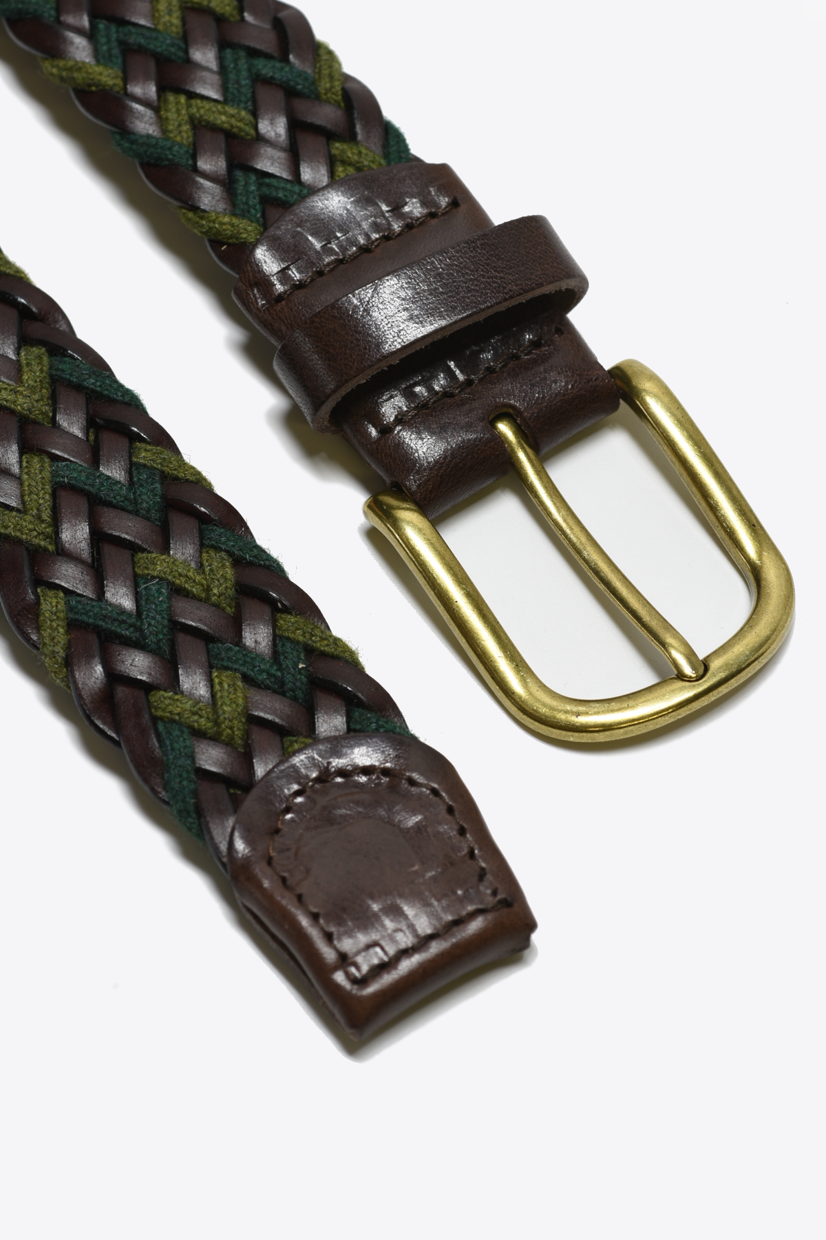 Woven belt with brown leather buckle and gold buckle on a white background