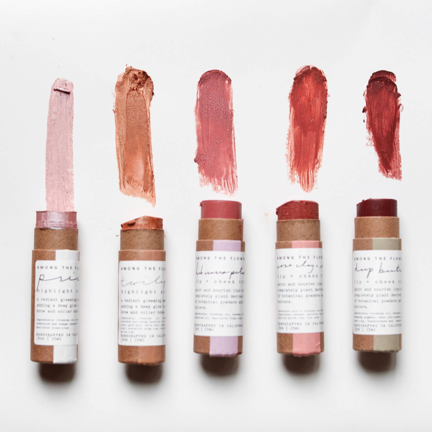 Set of six lip balm tubes with swatches on a white background