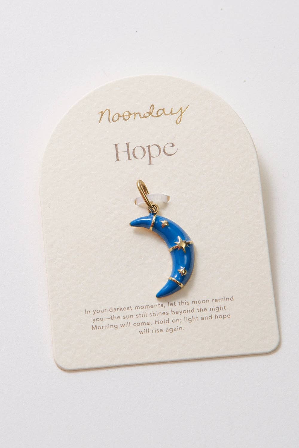 Blue moon pendant with gold accents on a 'Noonday Hope' card.
