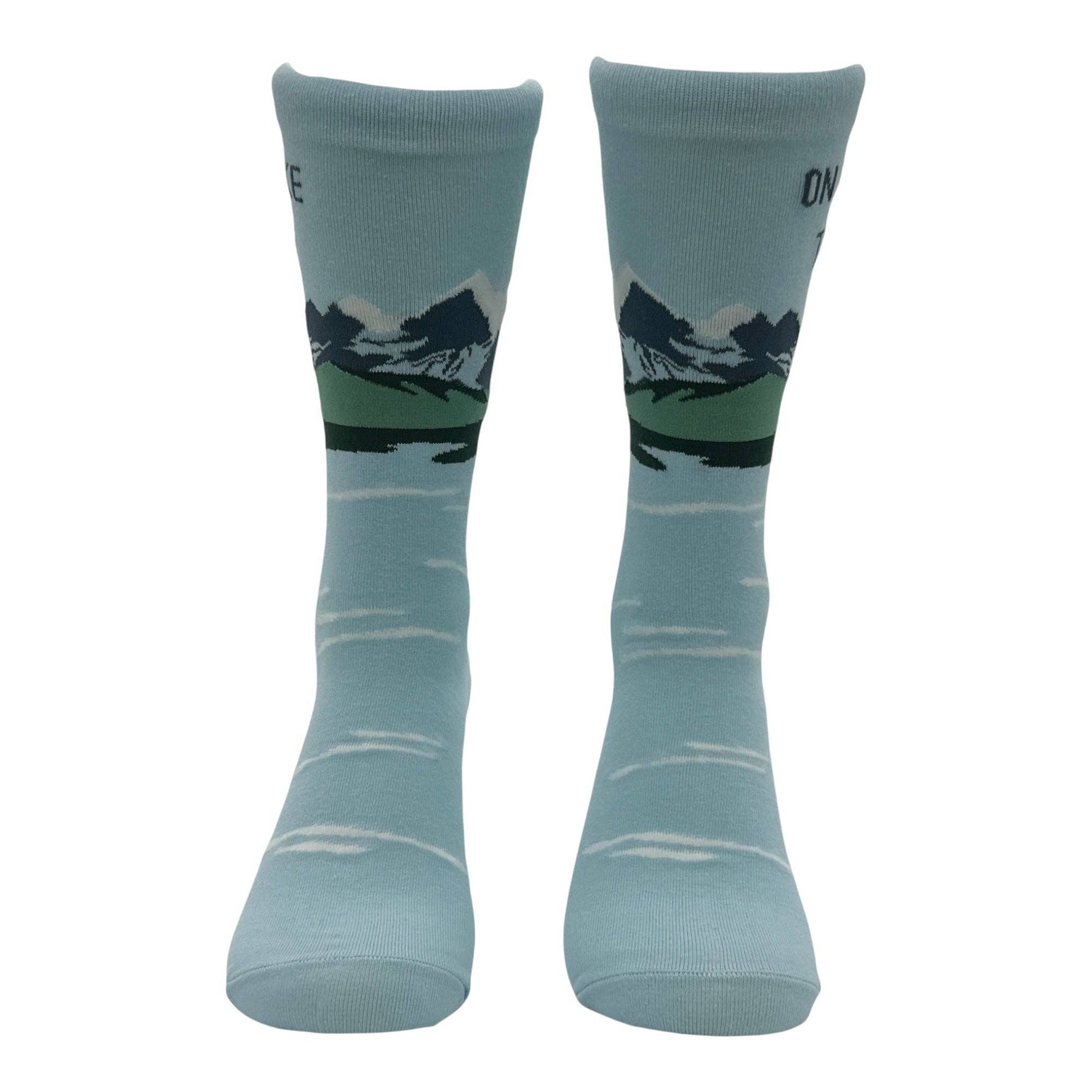 Pair of light blue socks with mountain design on a white background