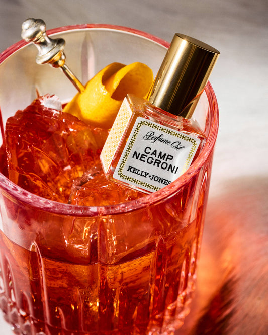 Camp Negroni cocktail with a bottle labeled 'Kelly Jones' in a red glass.