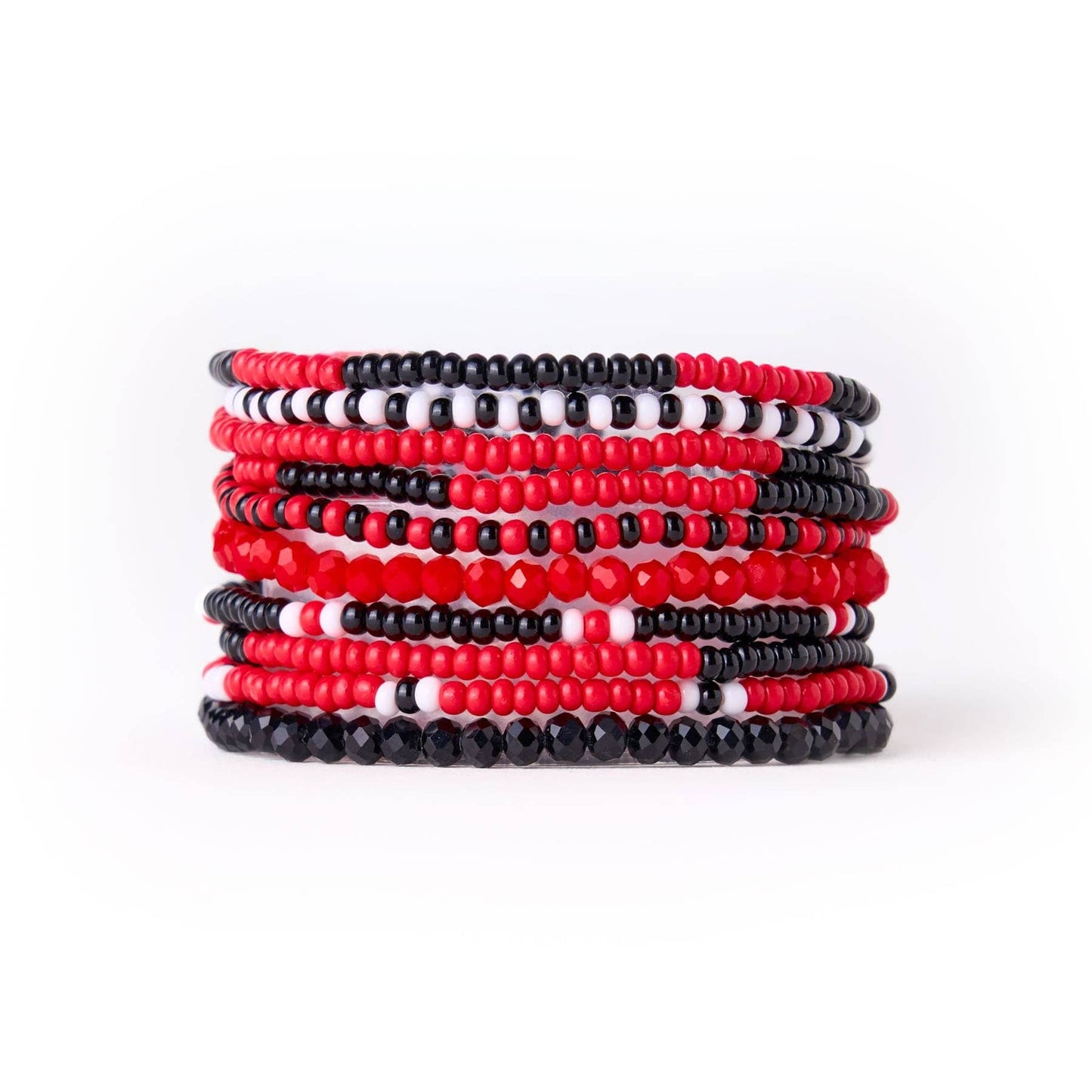 Stack of red, black, and white beaded bracelets on a white background