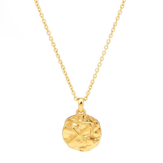Gold necklace with a round pendant on a white background