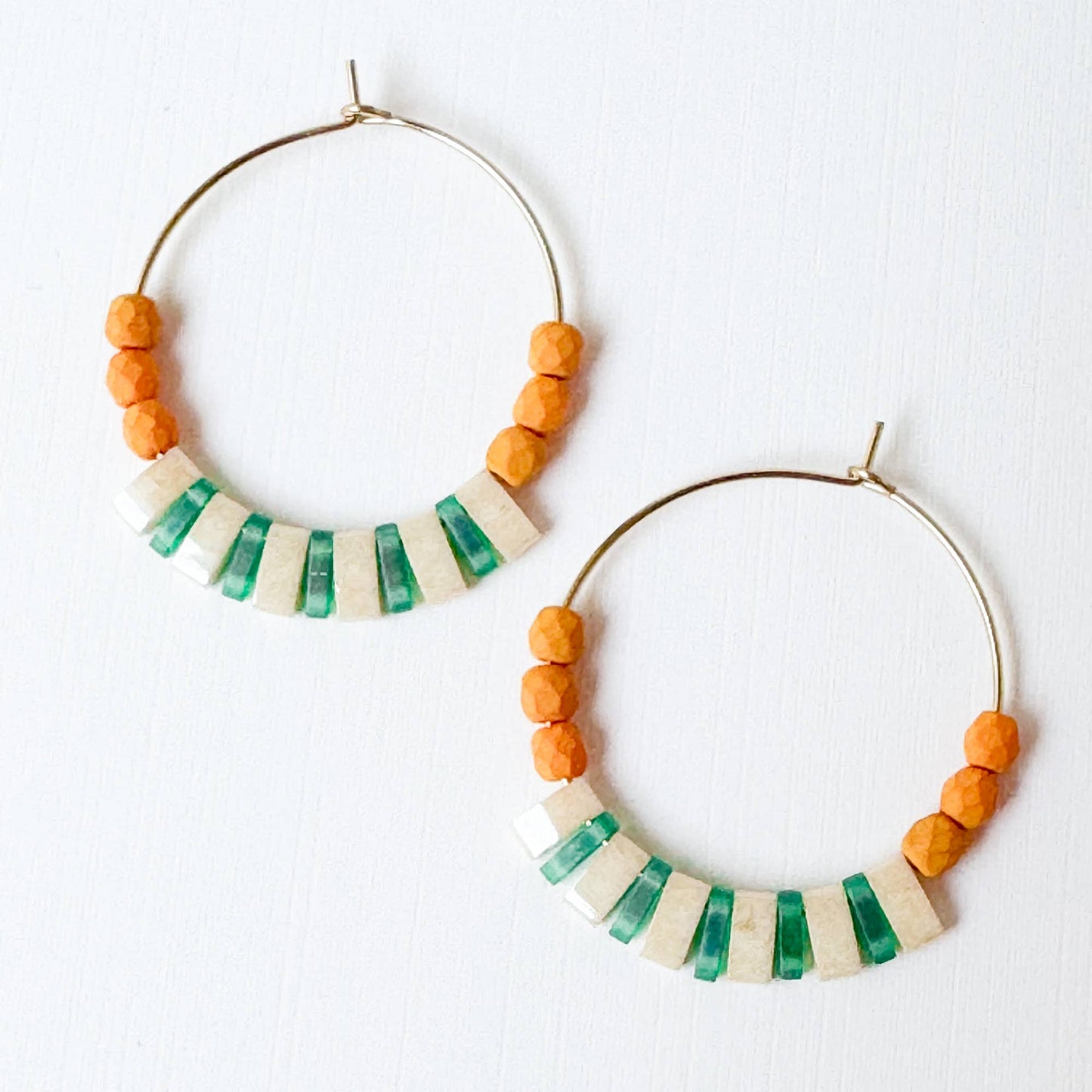 Hoop earrings with colorful bead designs on a white background