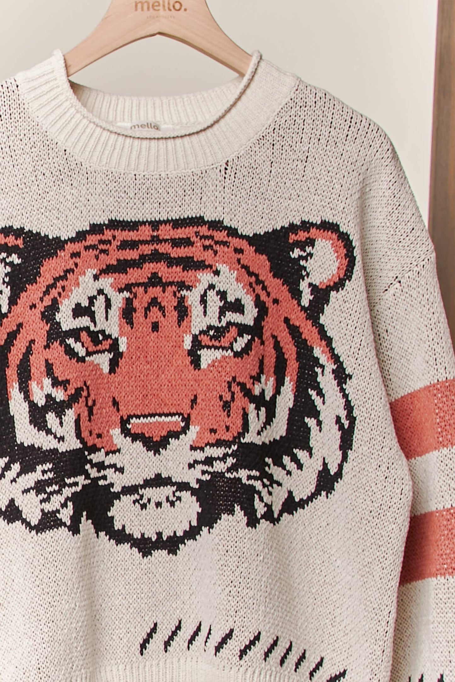 Sweater with a tiger design on a hanger