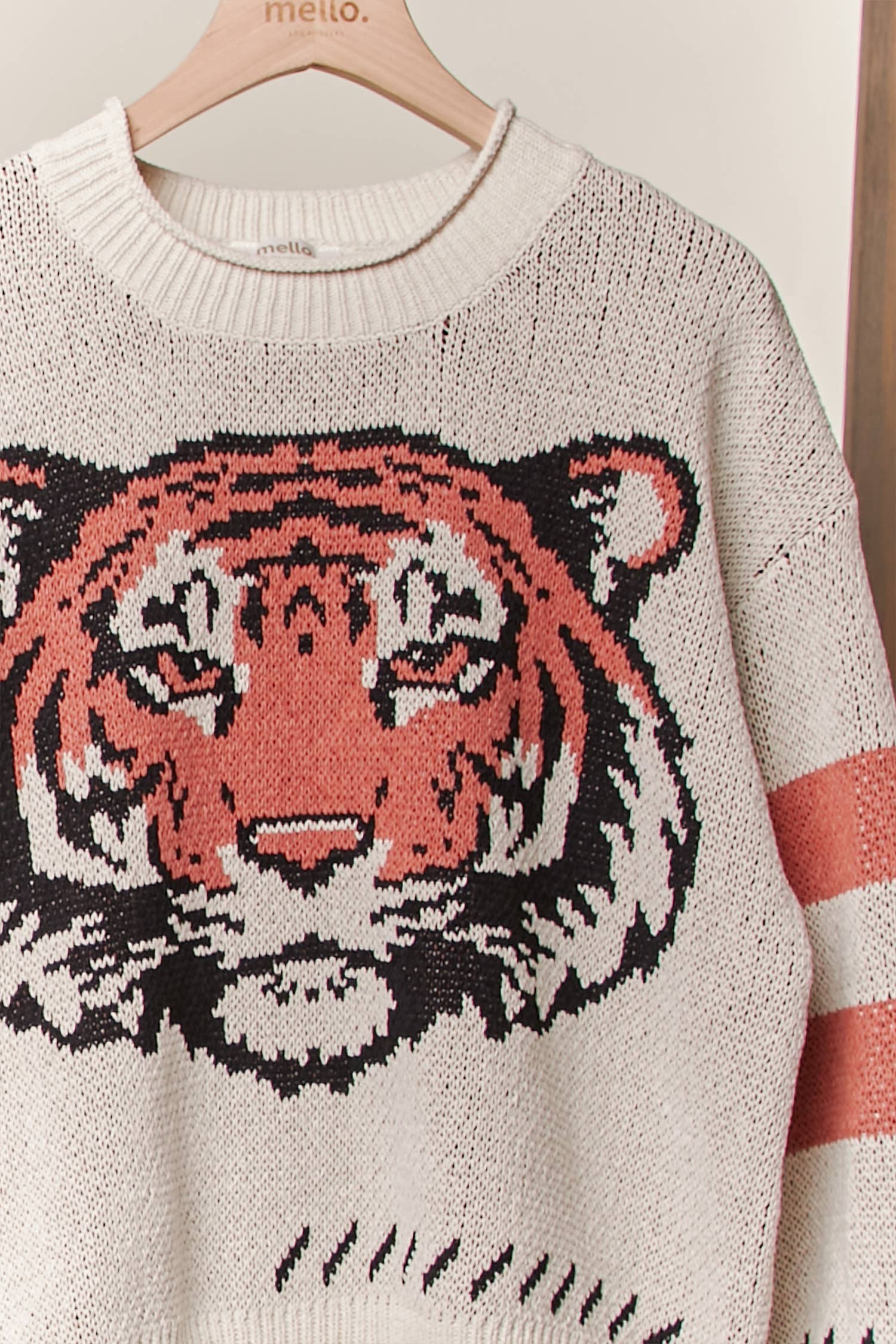 Sweater with a tiger design on a hanger