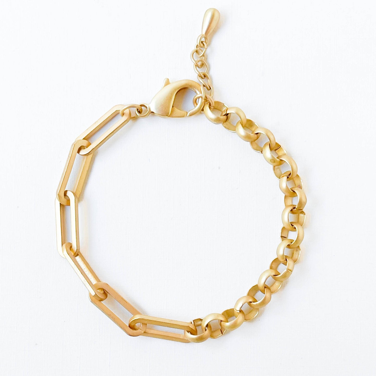 Gold bracelet with geometric design on a white background