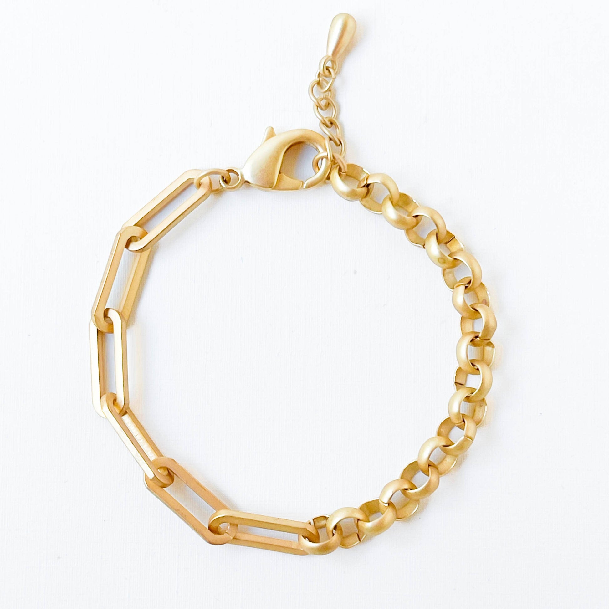 Gold bracelet with geometric design on a white background