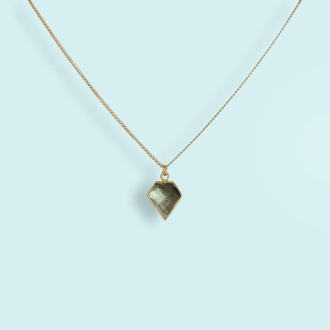 Necklace with a geometric pendant on a light blue background