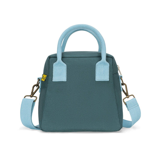 A small structured handbag in dark teal with light blue handles, trim, and detachable shoulder strap, plus gold-tone hardware, shown on a clean white background.