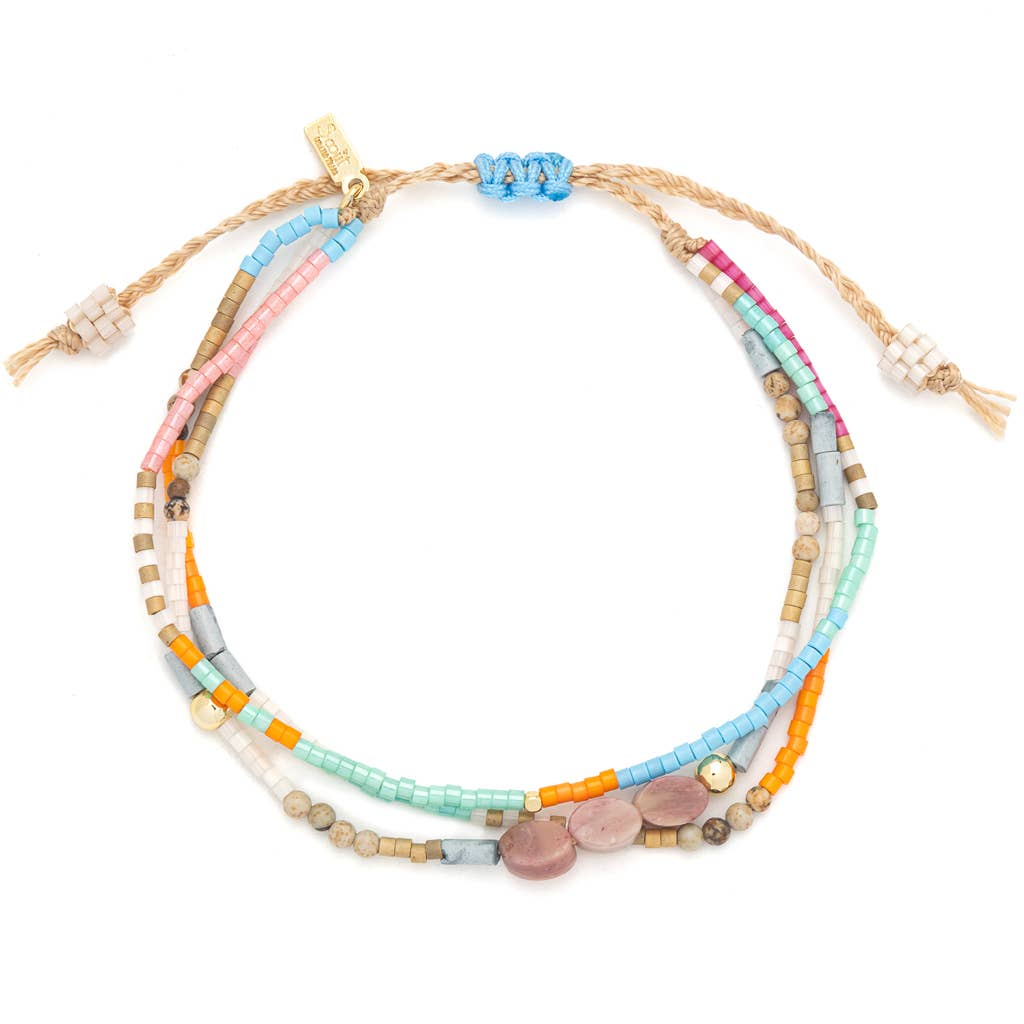 Set of colorful beaded bracelets on a white background