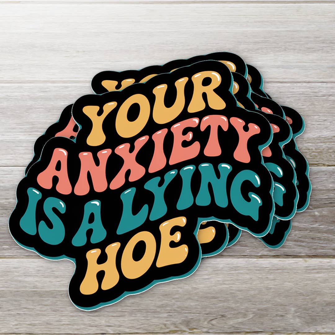 Stack of colorful stickers with text on a wooden surface
