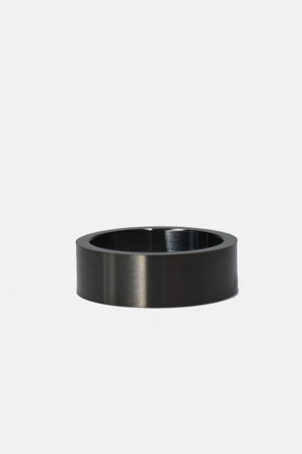 Black metal ring on a light gray background