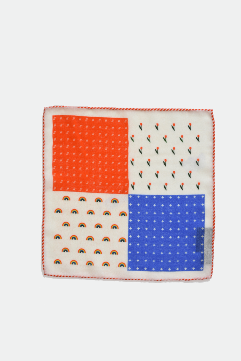 Square pocket square with orange, blue, and white pattern on a light gray background