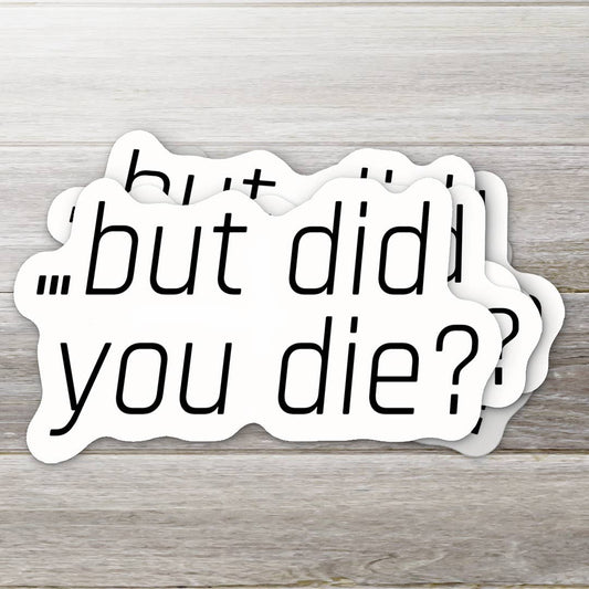 Two stickers with the text 'but did you die?' on a wooden surface