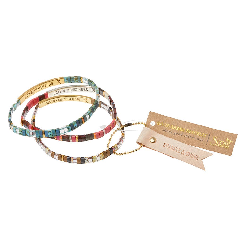 Set of colorful bracelets with a tag on a white background