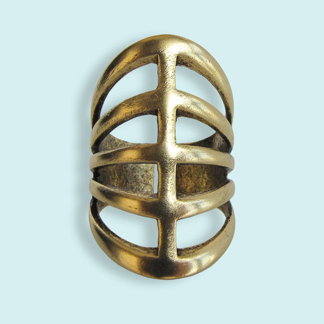 Gold ring with a geometric design on a light blue background