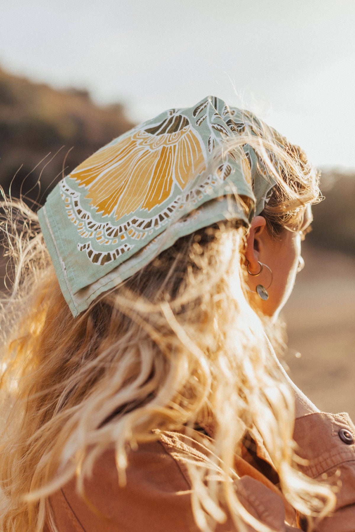 Person wearing a decorative headband with a floral design outdoors