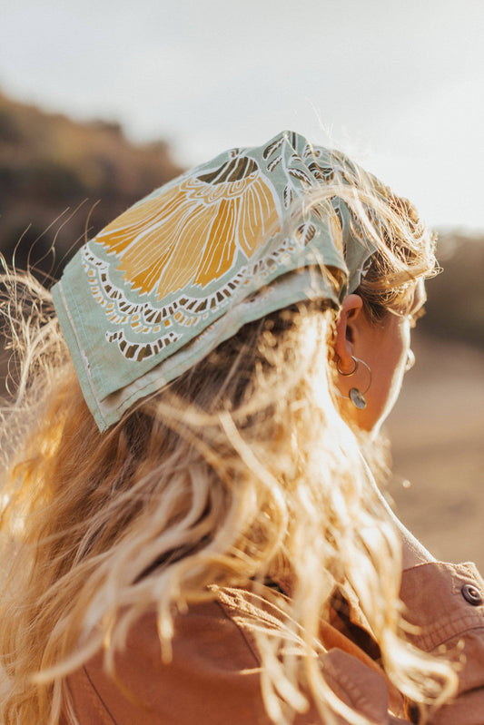 Person wearing a decorative headband with a floral design outdoors