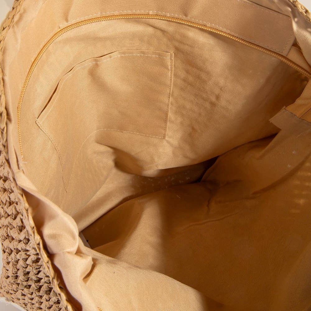 Close-up of a beige fabric with a textured surface and zipper detail.
