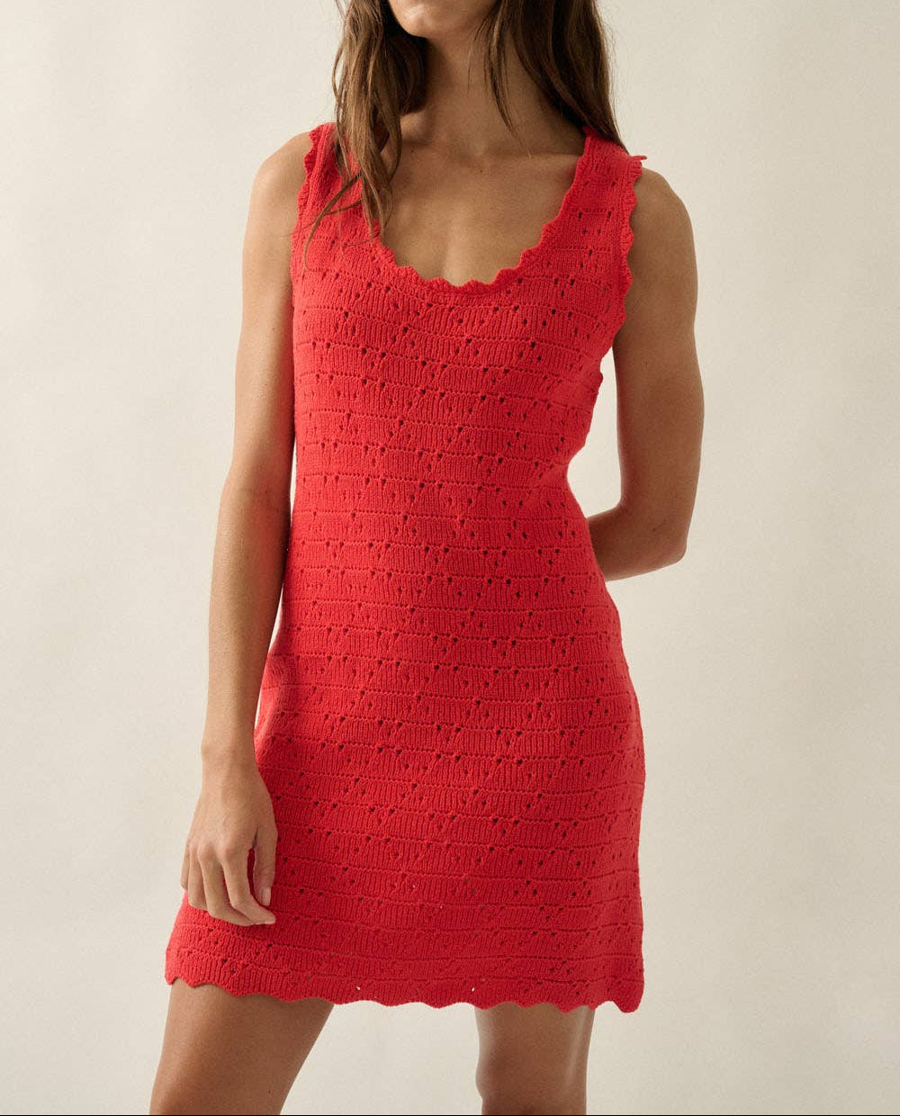 Woman wearing a red dress against a plain background