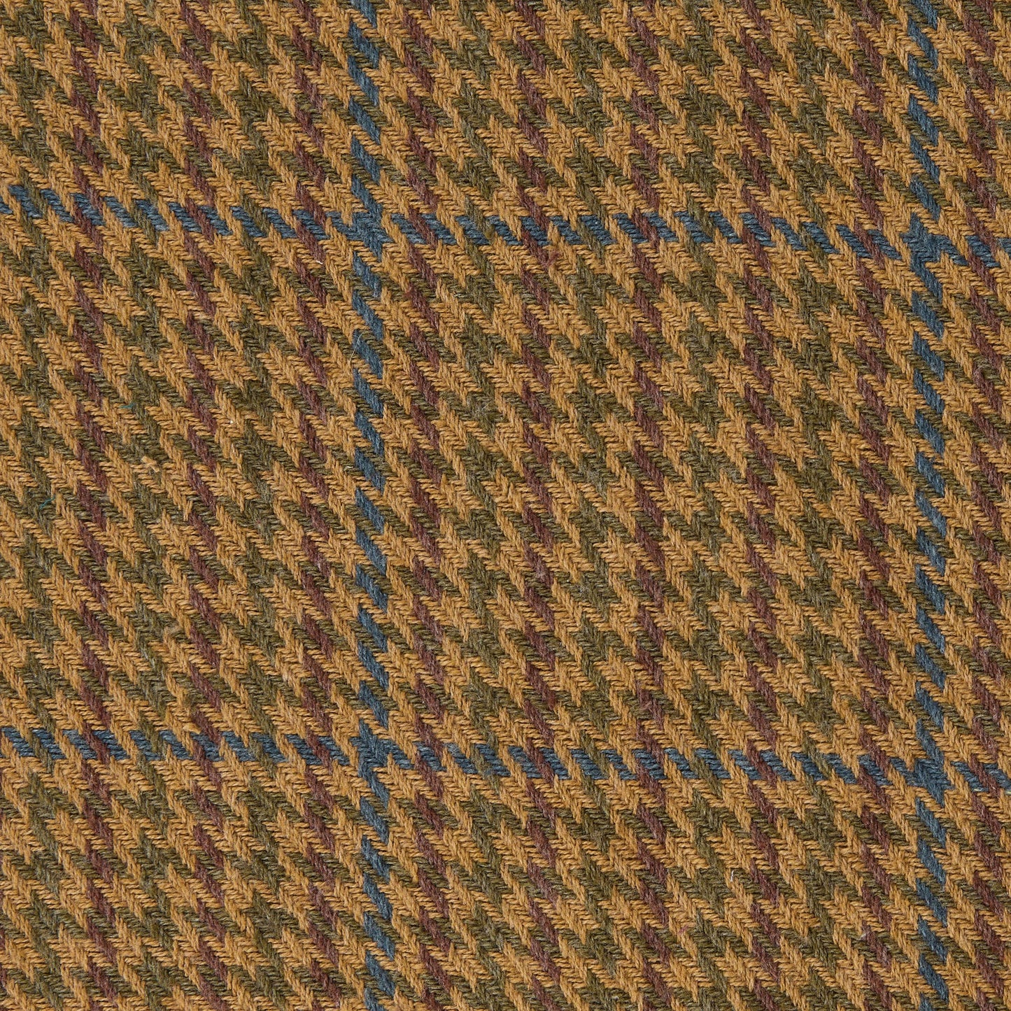 Close-up of a houndstooth pattern fabric with brown, green, and blue colors.