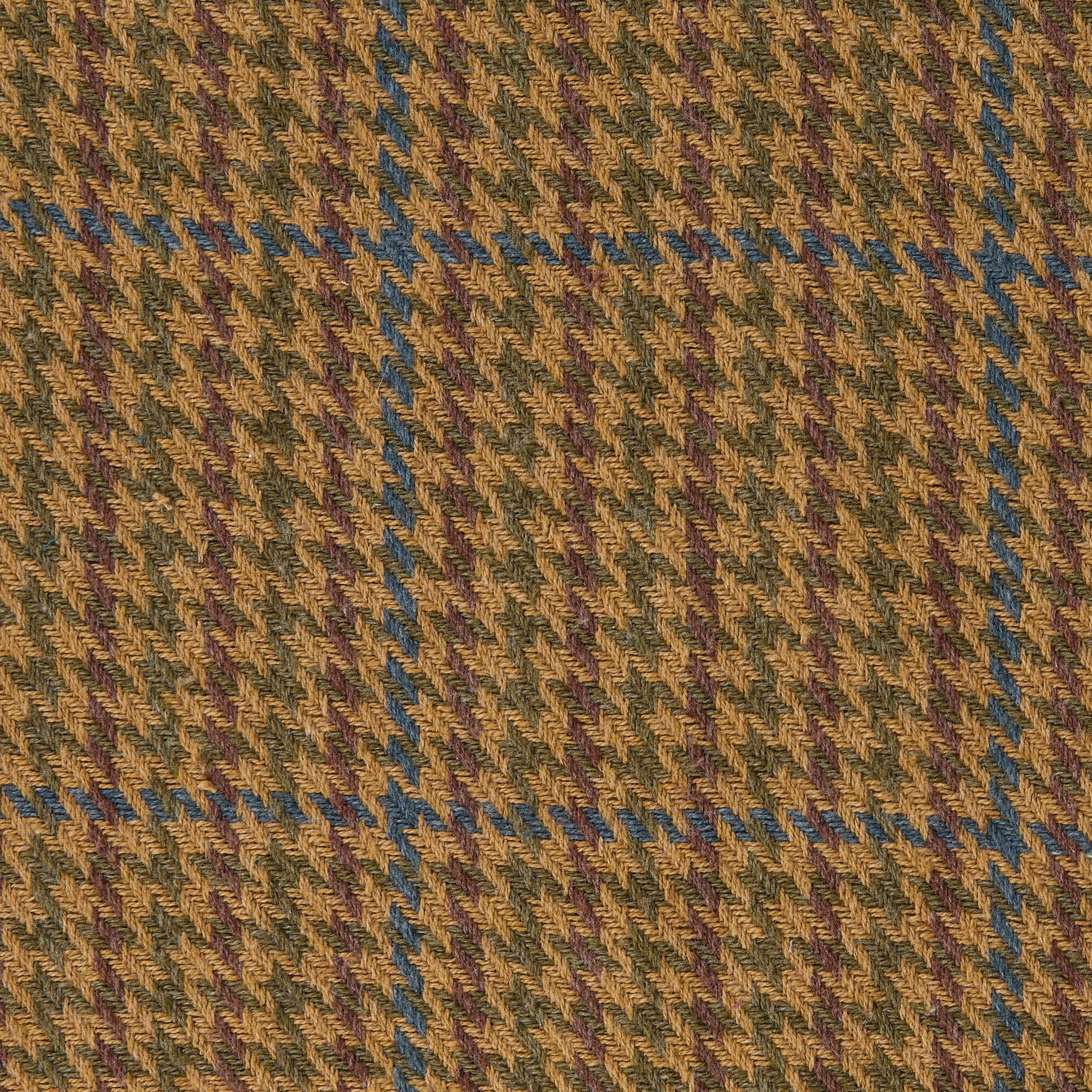 Close-up of a houndstooth pattern fabric with brown, green, and blue colors.