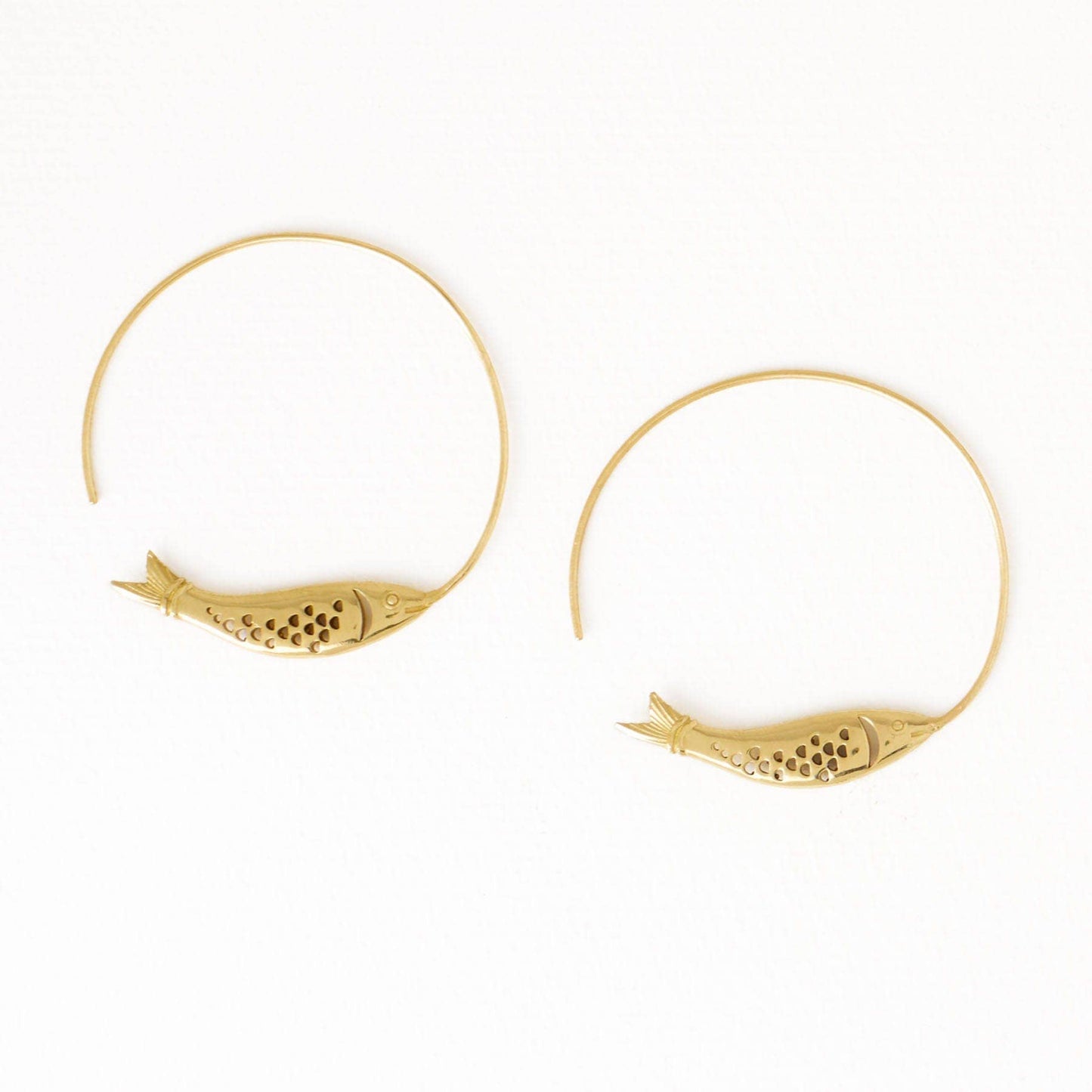 Gold hoop earrings with fish designs on a white background
