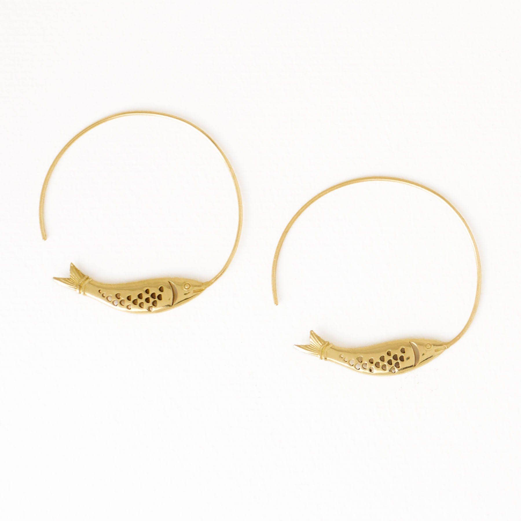Gold hoop earrings with fish designs on a white background